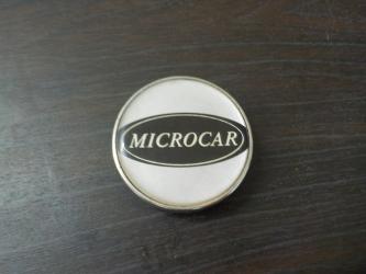 Logo Microcar  2434 (1J2)         piece voiture sans permis